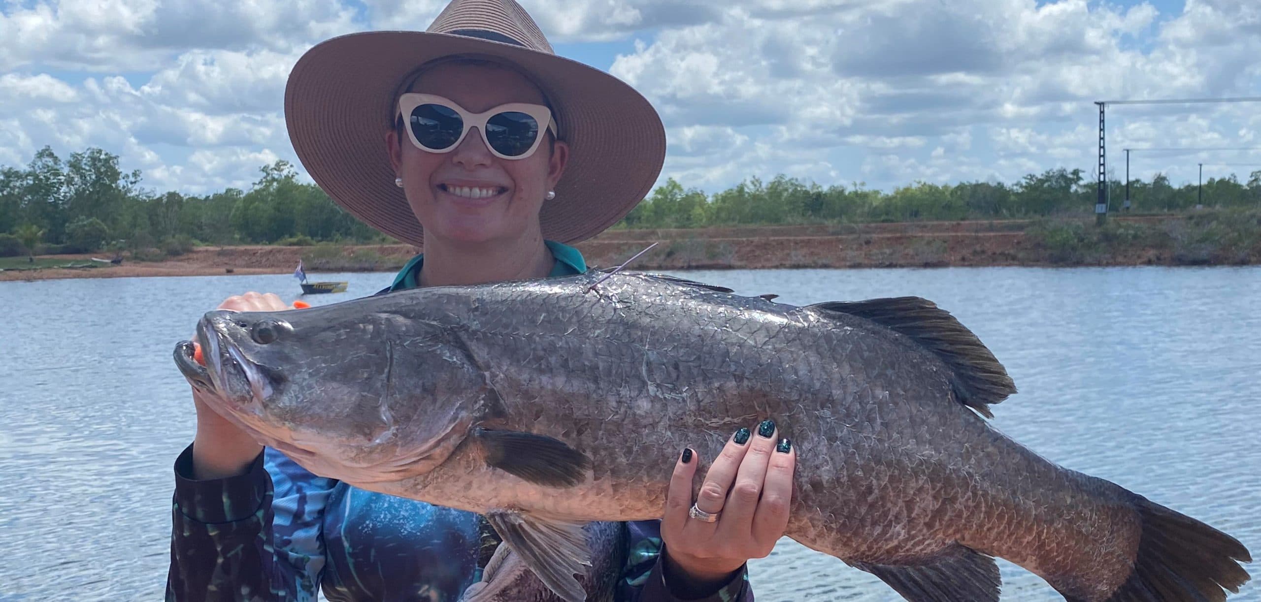 Lady holding up Bonus Charity Fish