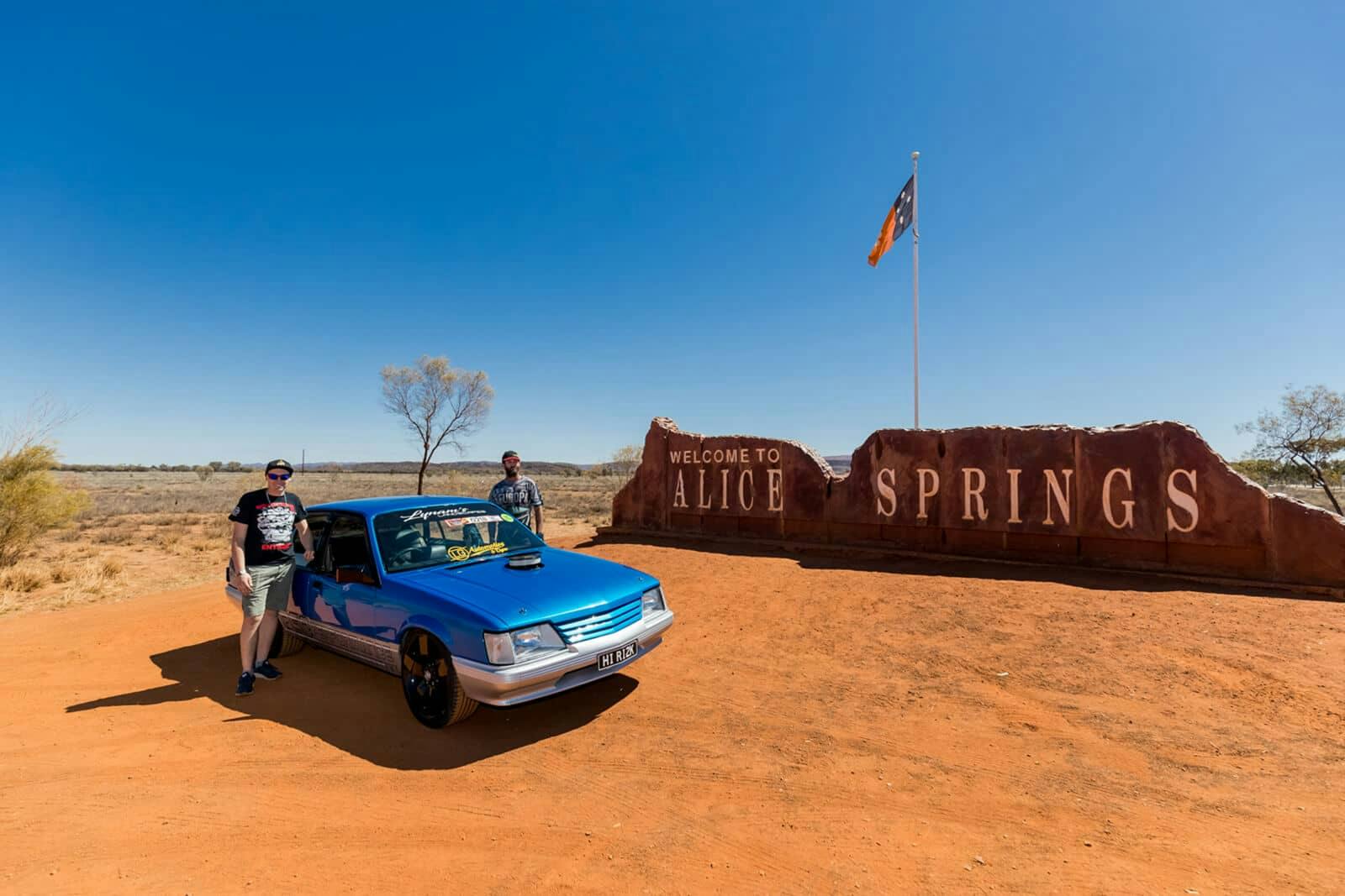Classic car in front of Alice Springs sign
