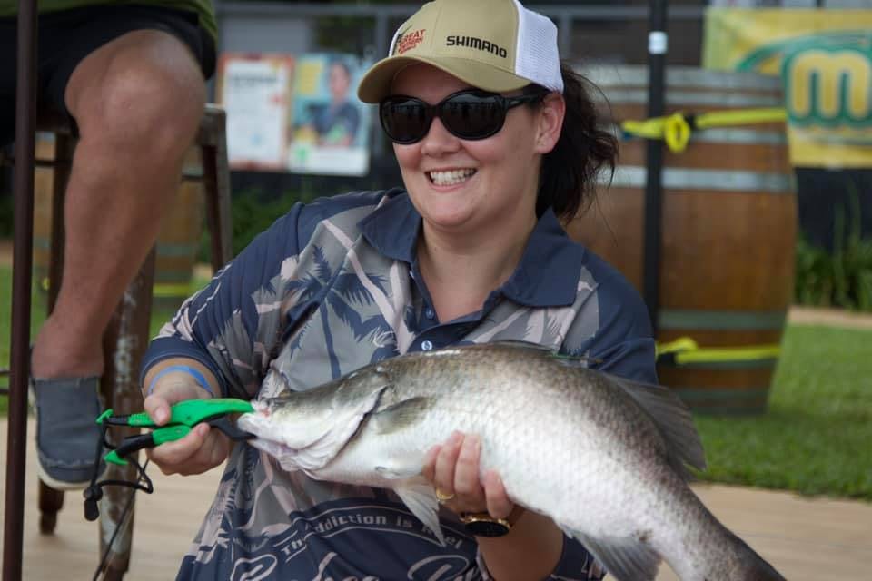 Woman holding a barra she has caught